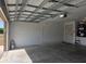 A spacious two-car garage featuring painted walls, concrete flooring, and an automatic door opener at 222 Locust Ln, Ocala, FL 34471