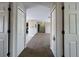 Hallway offers seamless transition between living areas featuring plush carpeting and convenient closet storage at 222 Locust Ln, Ocala, FL 34471