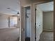 Hallway with closet storage and seamless transition to living area featuring plush carpeting, creating a welcoming atmosphere at 222 Locust Ln, Ocala, FL 34471
