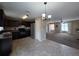 Open concept kitchen with dark cabinets, tile flooring, and stainless steel refrigerator at 222 Locust Ln, Ocala, FL 34471