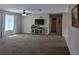Spacious living room with carpet, a ceiling fan, and a TV at 222 Locust Ln, Ocala, FL 34471