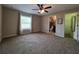 Spacious carpeted primary bedroom with a ceiling fan and ensuite bathroom at 222 Locust Ln, Ocala, FL 34471