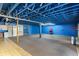 Unfinished basement with painted ceiling beams and painted walls at 2400 N Griffin Dr, Leesburg, FL 34748