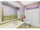 Bathroom featuring a large mirror, neutral tile and shower/tub combo at 2400 N Griffin Dr, Leesburg, FL 34748