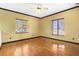 Bedroom with hardwood floors, ceiling fan and natural light at 2400 N Griffin Dr, Leesburg, FL 34748