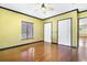 Bright bedroom with hardwood floors, closet space and a large window offering plenty of natural light and comfort at 2400 N Griffin Dr, Leesburg, FL 34748