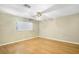 Spacious bedroom with hardwood floors and a ceiling fan and natural light at 2400 N Griffin Dr, Leesburg, FL 34748