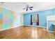 Bonus room with lots of light and character boasting hardwood floors, ceiling fan and a multi-colored wall at 2400 N Griffin Dr, Leesburg, FL 34748