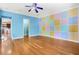Bonus room boasts hard wood floors, a ceiling fan, and a multi-colored wall that adds visual interest at 2400 N Griffin Dr, Leesburg, FL 34748
