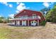 Two-story home features multiple doors, large deck, and lush landscaping at 2400 N Griffin Dr, Leesburg, FL 34748