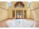 Bright foyer with high ceilings, tile flooring, and decorative glass doors leading to the front yard at 2400 N Griffin Dr, Leesburg, FL 34748