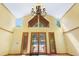 Bright foyer with vaulted ceilings, large windows, and glass doors leading to the front yard at 2400 N Griffin Dr, Leesburg, FL 34748