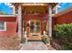 Elegant entryway featuring stone pillars, double doors, and meticulous landscaping at 2400 N Griffin Dr, Leesburg, FL 34748