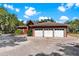 Elegant home featuring a 3-car garage, landscaped yard, and brick paved circular driveway at 2400 N Griffin Dr, Leesburg, FL 34748