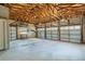Spacious garage with multiple car doors and exposed wooden beams at 2400 N Griffin Dr, Leesburg, FL 34748