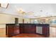 Large kitchen with wood floors, granite counters, wood cabinets, stainless steel appliances and water views at 2400 N Griffin Dr, Leesburg, FL 34748