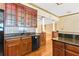 Open concept kitchen featuring hardwood floors, wood cabinets, tile backsplash and granite countertops at 2400 N Griffin Dr, Leesburg, FL 34748