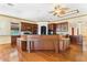 Gourmet kitchen featuring custom cabinetry, granite counters, and a center island with seating at 2400 N Griffin Dr, Leesburg, FL 34748