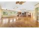 Bright, open living room with hardwood floors, ceiling fans, and ample natural light at 2400 N Griffin Dr, Leesburg, FL 34748