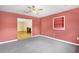Living room featuring carpet, built-in shelving and ample space at 2400 N Griffin Dr, Leesburg, FL 34748