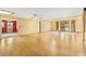 Bright living room with wood floors, textured walls, and access to other rooms at 2400 N Griffin Dr, Leesburg, FL 34748