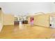 Open living room space with wooden floors leading to a light-filled area with a bar at 2400 N Griffin Dr, Leesburg, FL 34748