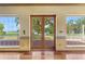 Large living room with hardwood floors, double doors to the deck, and lots of natural light at 2400 N Griffin Dr, Leesburg, FL 34748
