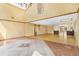 Open floor plan with tile and hardwood floors, complemented by high ceilings and natural light at 2400 N Griffin Dr, Leesburg, FL 34748