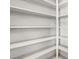 This pantry has painted shelves and ample storage space at 2400 N Griffin Dr, Leesburg, FL 34748