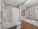 Bathroom with a shower/tub, decorative mirror, and a vanity with solid surface countertop at 2450 Kingstree Pl, The Villages, FL 32162