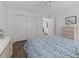 Well-lit bedroom featuring a sliding closet and ceiling fan at 2450 Kingstree Pl, The Villages, FL 32162