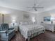 Calm bedroom with wood floors, white wicker furniture, and soft blue accents at 2450 Kingstree Pl, The Villages, FL 32162