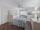 Cozy bedroom featuring a floral comforter, bedside tables, and ceiling fan at 2450 Kingstree Pl, The Villages, FL 32162