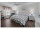 Serene bedroom with hard wood floors, and a comfortable white wicker bed at 2450 Kingstree Pl, The Villages, FL 32162