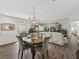 Chandelier lit dining area flows into living room with an open concept design at 2450 Kingstree Pl, The Villages, FL 32162