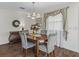 Elegant dining area featuring a chandelier, hardwood floors, and stylish decor at 2450 Kingstree Pl, The Villages, FL 32162