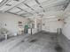 Spacious garage with laundry sink, water heater, storage and automatic door at 2450 Kingstree Pl, The Villages, FL 32162
