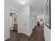 Hallway with bathroom door, wood-look flooring and ample lighting at 2450 Kingstree Pl, The Villages, FL 32162