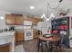 Cozy kitchen featuring oak cabinets, modern appliances, and a charming dining area at 2450 Kingstree Pl, The Villages, FL 32162