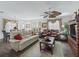 Bright living room featuring wood floors, a ceiling fan, and comfortable seating arrangements at 2450 Kingstree Pl, The Villages, FL 32162