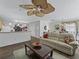 Open living area featuring wood floors, neutral walls, and a modern ceiling fan at 2450 Kingstree Pl, The Villages, FL 32162
