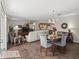 Open-concept living space with hardwood floors connecting the living, dining, and kitchen areas at 2450 Kingstree Pl, The Villages, FL 32162