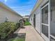 Outdoor patio featuring a grill, concrete flooring, and access to the home's screened lanai at 2450 Kingstree Pl, The Villages, FL 32162