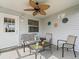 This screened in patio has a ceiling fan and outdoor seating at 2450 Kingstree Pl, The Villages, FL 32162