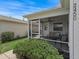 Relaxing screened porch with comfortable seating and a ceiling fan for outdoor enjoyment at 2450 Kingstree Pl, The Villages, FL 32162