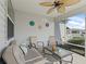 Relax in this screened porch with a ceiling fan, perfect for outdoor relaxation and entertaining at 2450 Kingstree Pl, The Villages, FL 32162