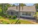 Backyard featuring a screened-in lanai and a well-maintained lawn, providing a perfect space for outdoor relaxation at 25129 Riverwalk Dr, Leesburg, FL 34748
