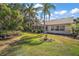 Spacious backyard featuring a screened-in lanai and lush landscaping, providing a serene outdoor living experience at 25129 Riverwalk Dr, Leesburg, FL 34748