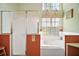 Bathroom featuring a soaking tub, glass shower, decorative elements, and bright natural light at 25129 Riverwalk Dr, Leesburg, FL 34748