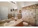 Bathroom featuring a vanity with tile countertop and decorative palm tree shower curtain at 25129 Riverwalk Dr, Leesburg, FL 34748
